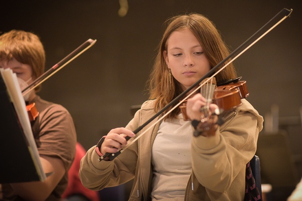 Students playing violins.