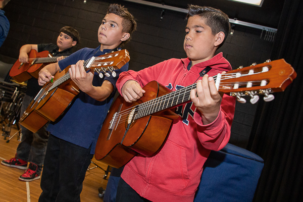 Students playing guitars.