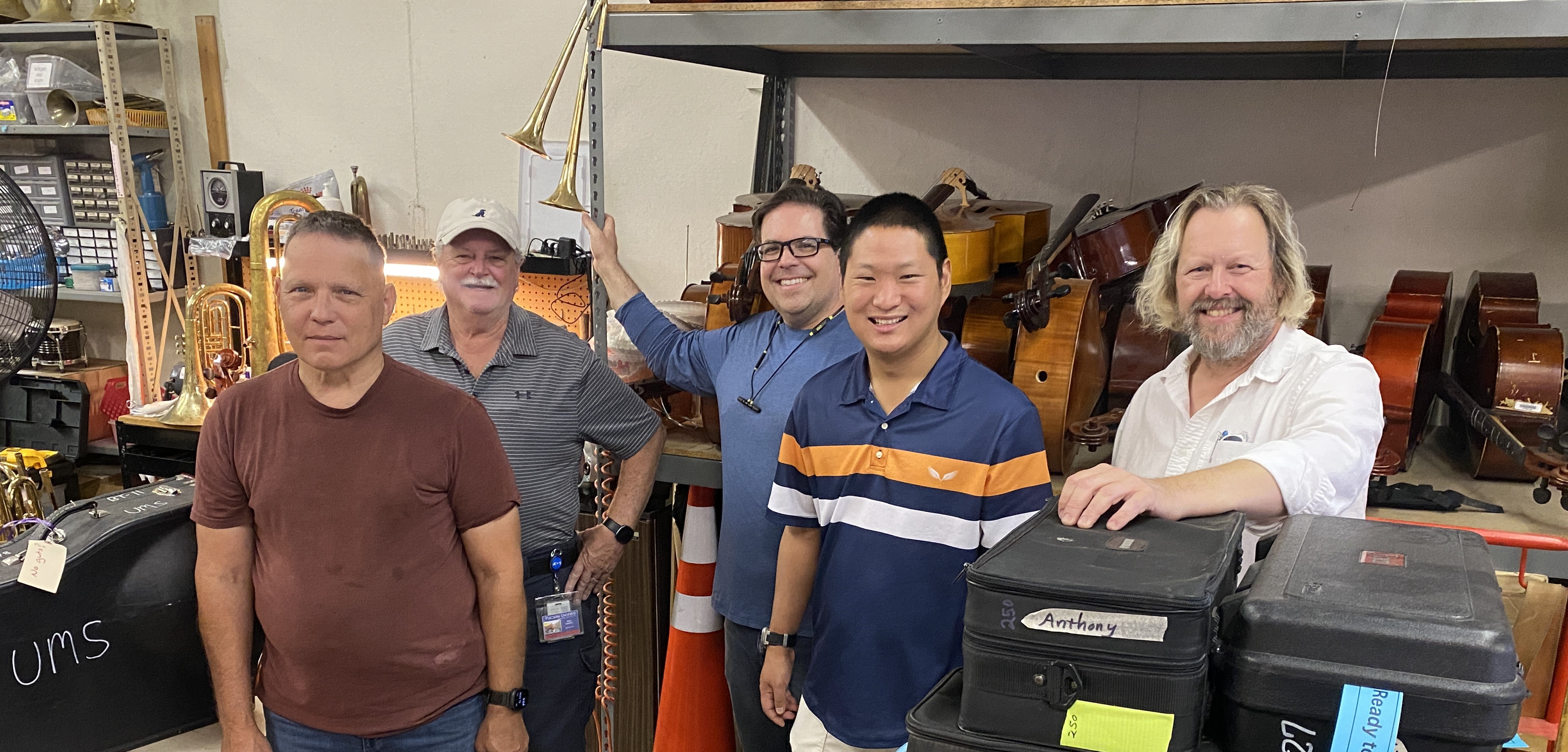 Musicians standing in an instrument repair shop