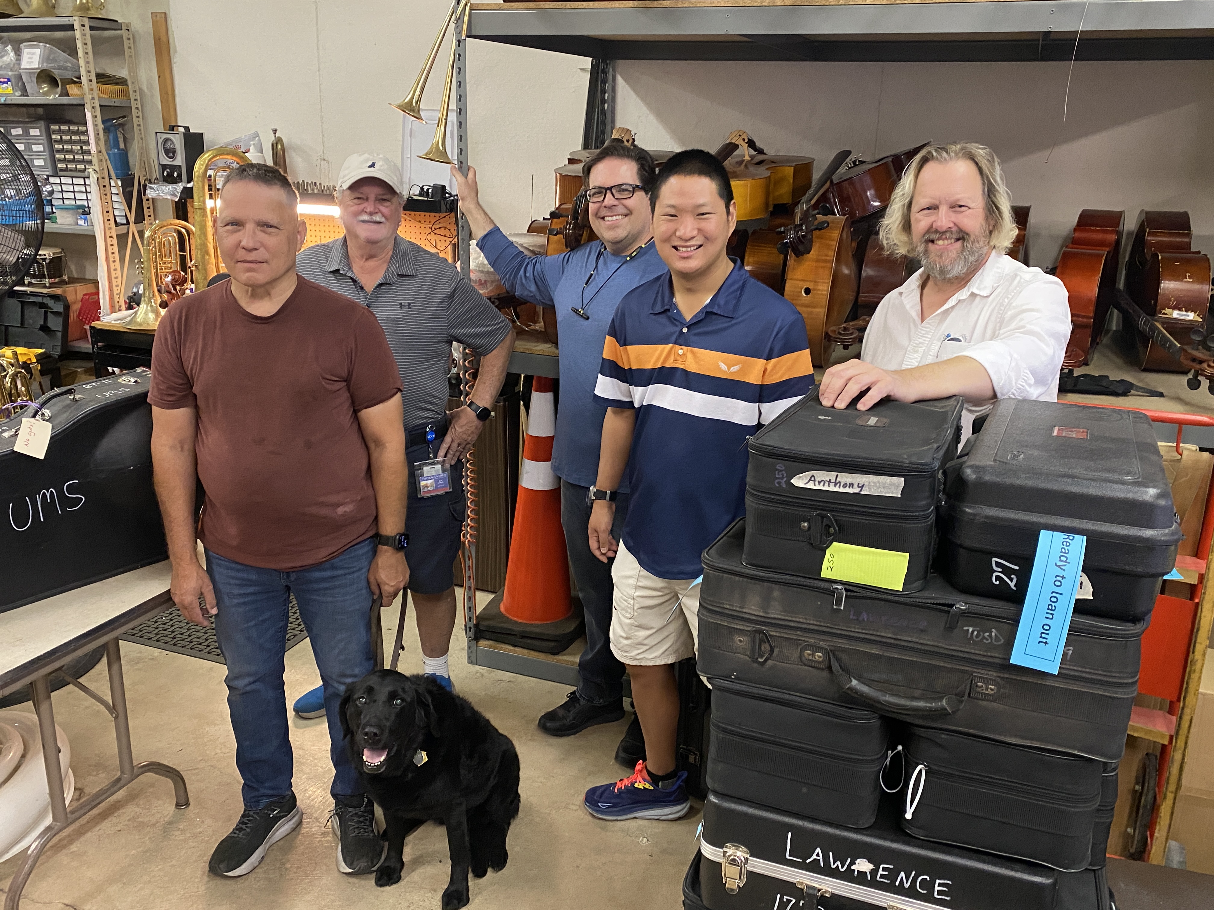 Musicians standing in an instrument repair shop